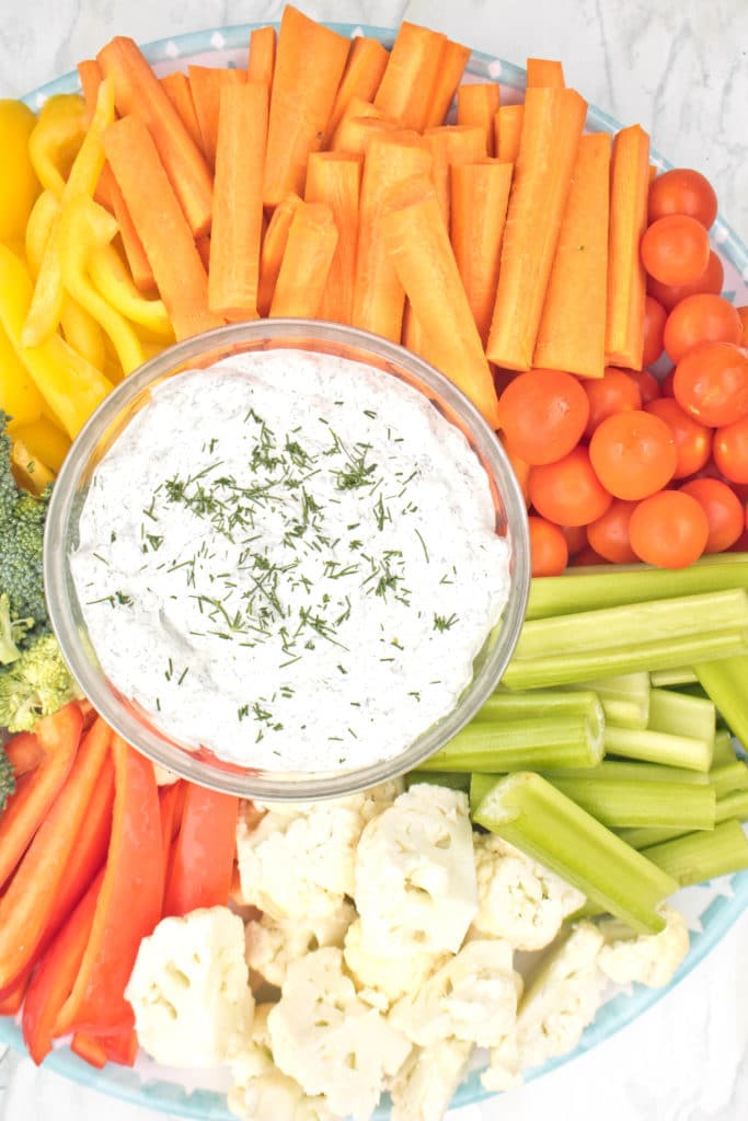 veggie plate with a dill dip in the center.