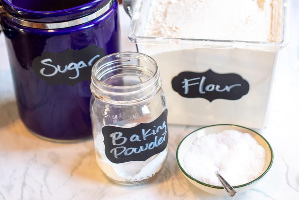 sugar, flour, baking powder, and salt on a counter