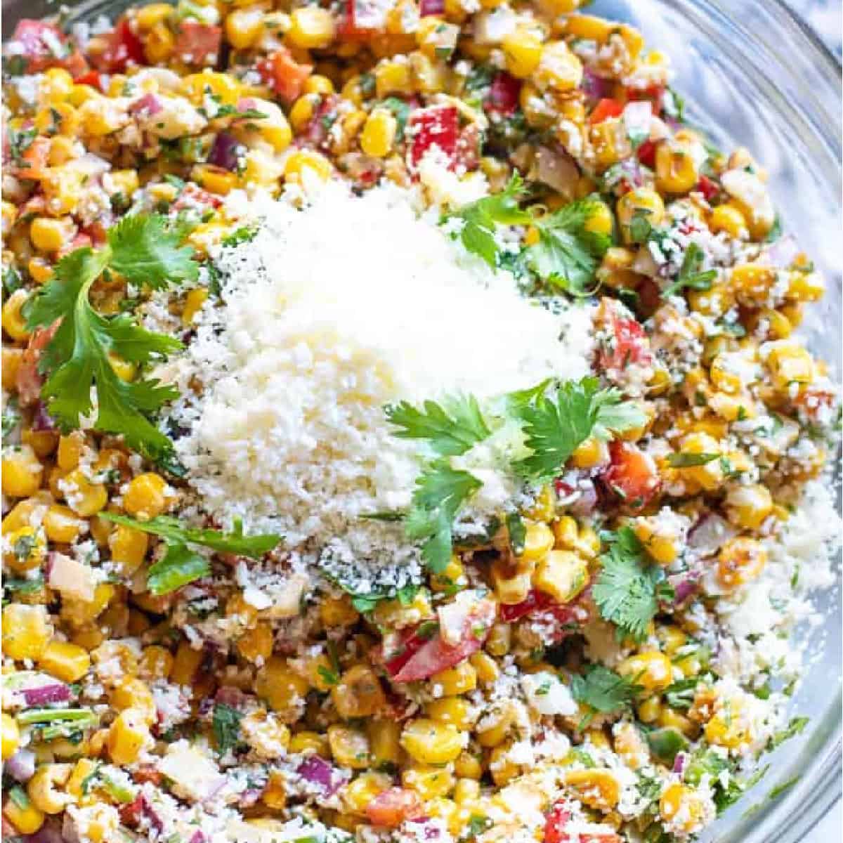 a bowl of corn salad with cotija and cilantro.