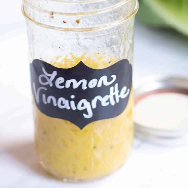an open mason jar with a label that says Lemon Vinaigrette and vinaigrette in it.
