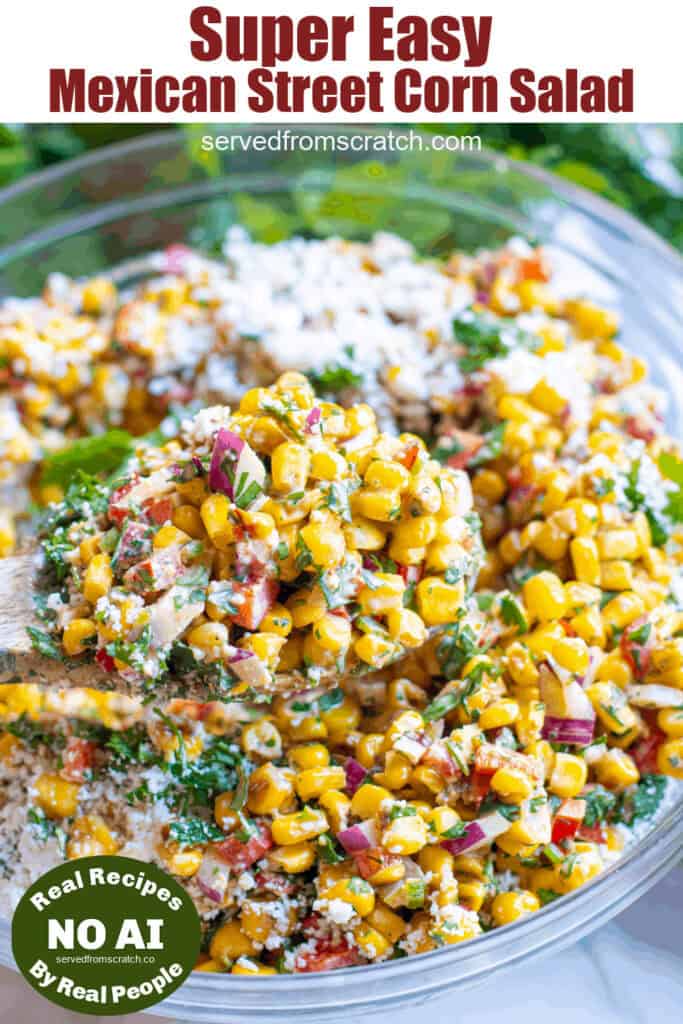 a big bowl of street corn salad with a spoon and Pinterest pin text.