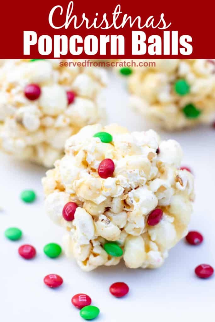 popcorn ball with Christmas M&M and Pinterest pin text.