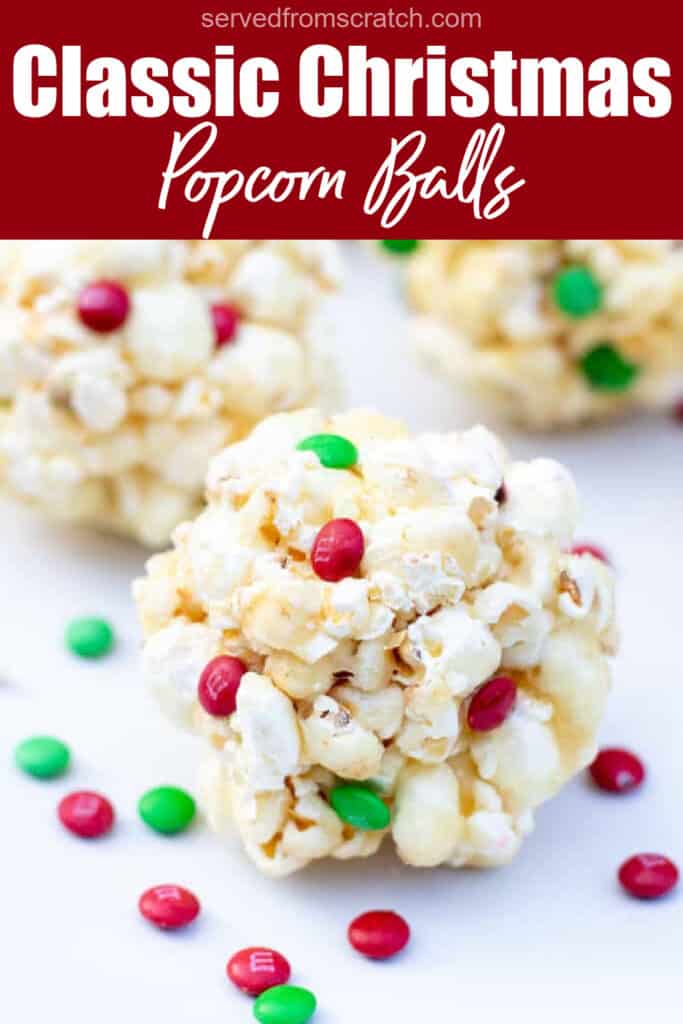 a close up of a popcorn ball with christmas colored m&ms with Pinterest pin text.