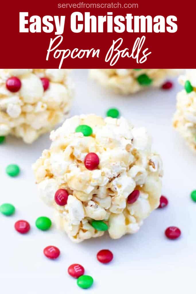 a close up of a popcorn ball with christmas colored m&ms with Pinterest pin text.