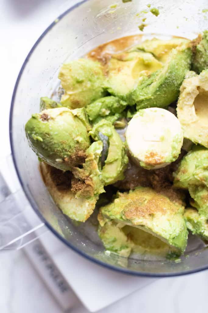 food processor of avocados and cumin.