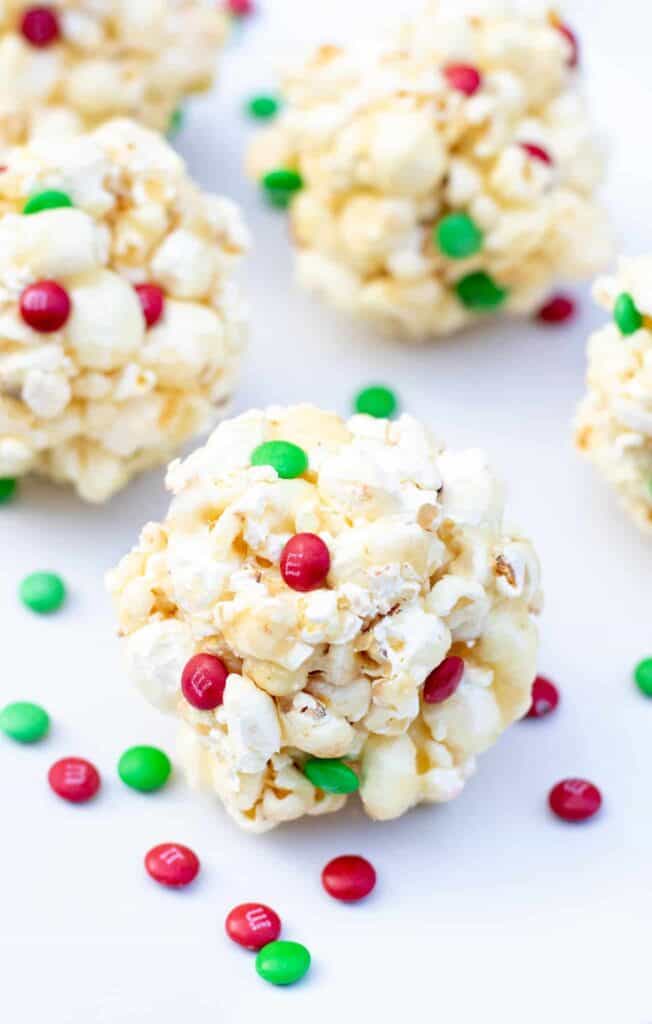 popcorn balls with Christmas colored mini M&Ms.