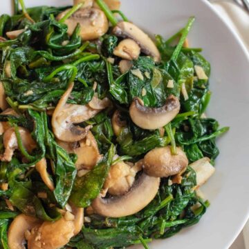 a bowl of sauteed spinach and mushrooms