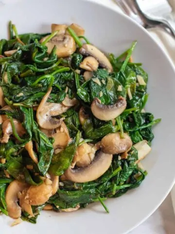 a bowl of sauteed spinach and mushrooms