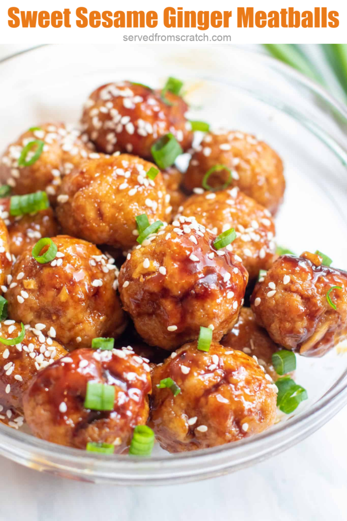 a bowl of sesame seed and green onion topped meatballs with Pinterest pin text.