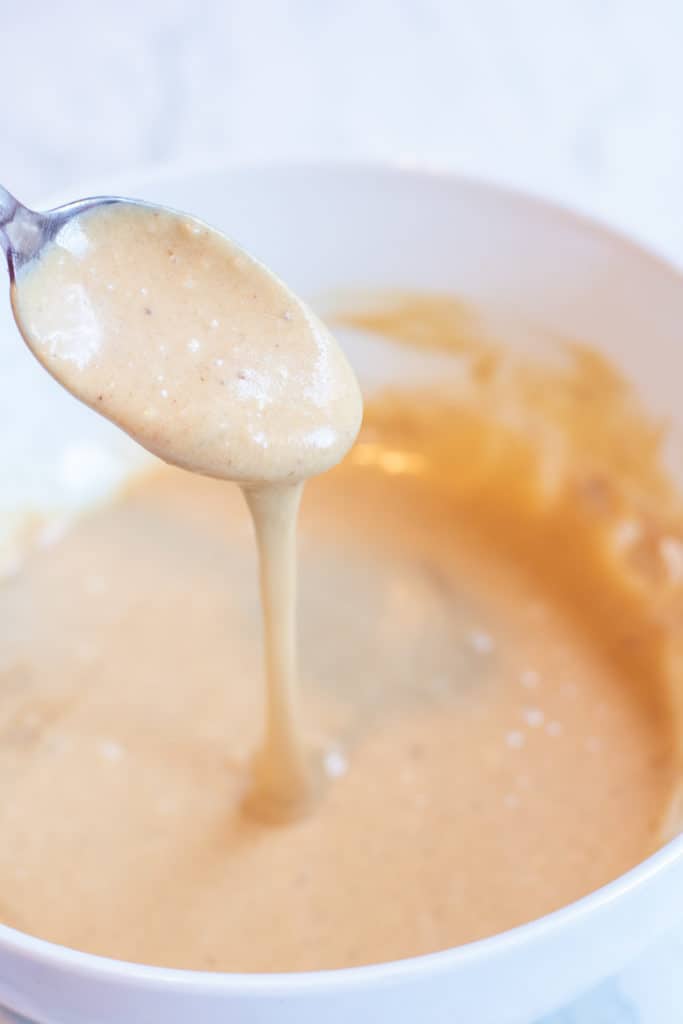 a spoon in a bowl of glaze.