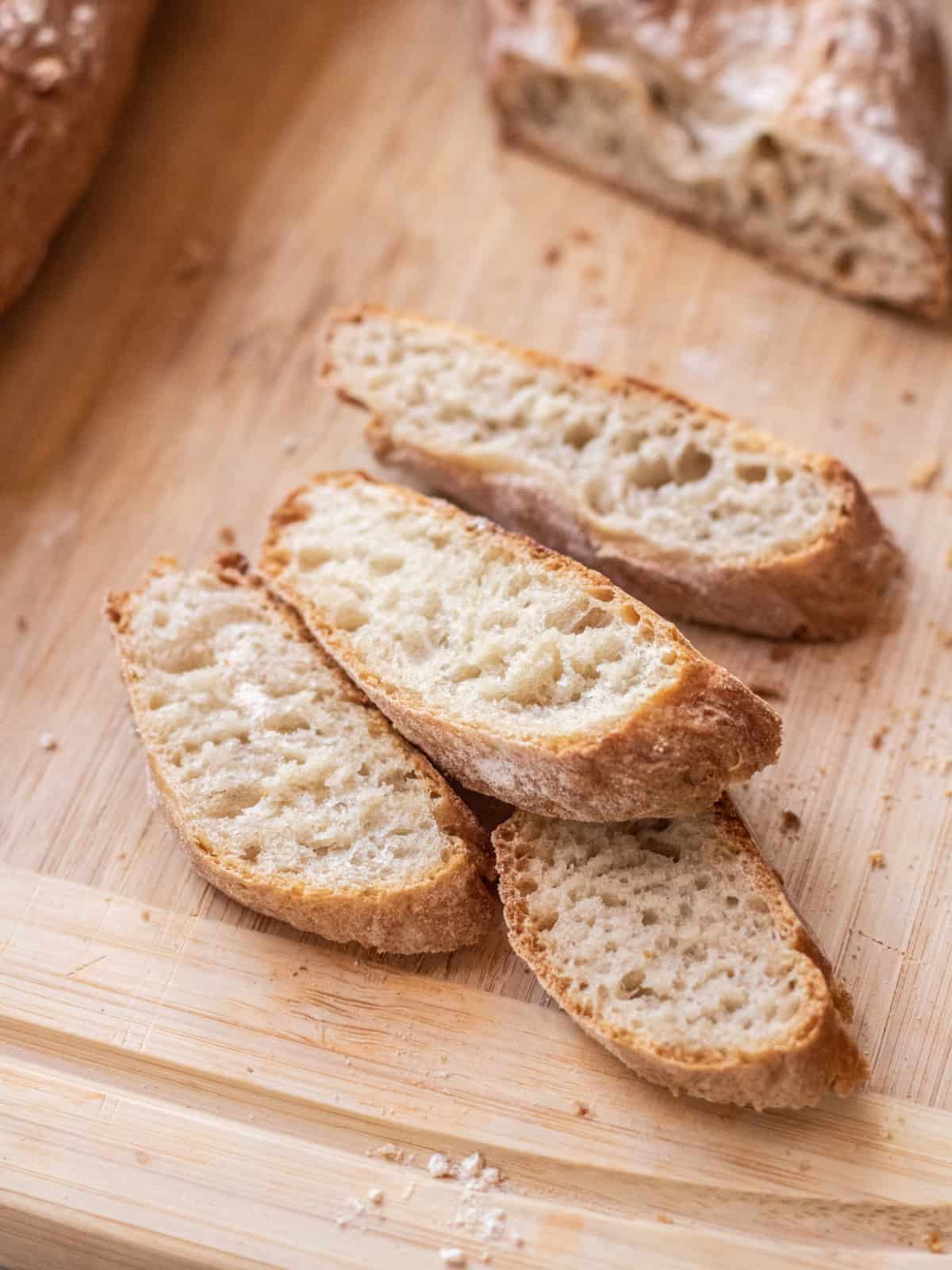 slices of baguette on a cutting board.