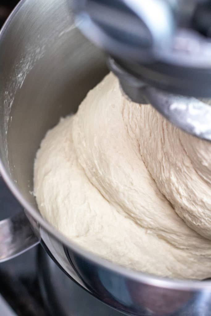 dough being mixed in a stand mixer.