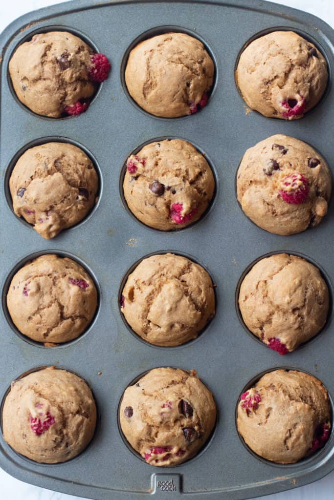 fresh baked chocolate chip raspberry muffins in tin