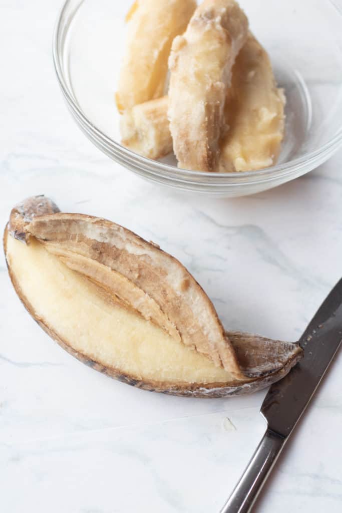 peeled frozen banana and frozen banana in  bowl