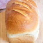 a loaf of white bread on a cutting board.