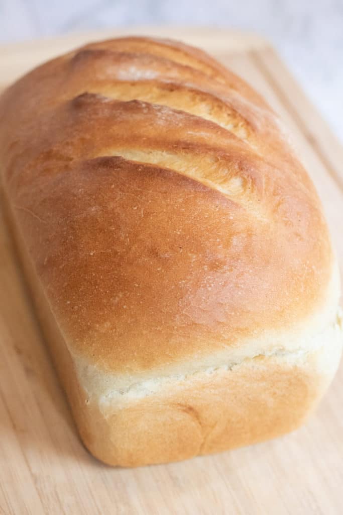 loaf of white bread on a cutting board.