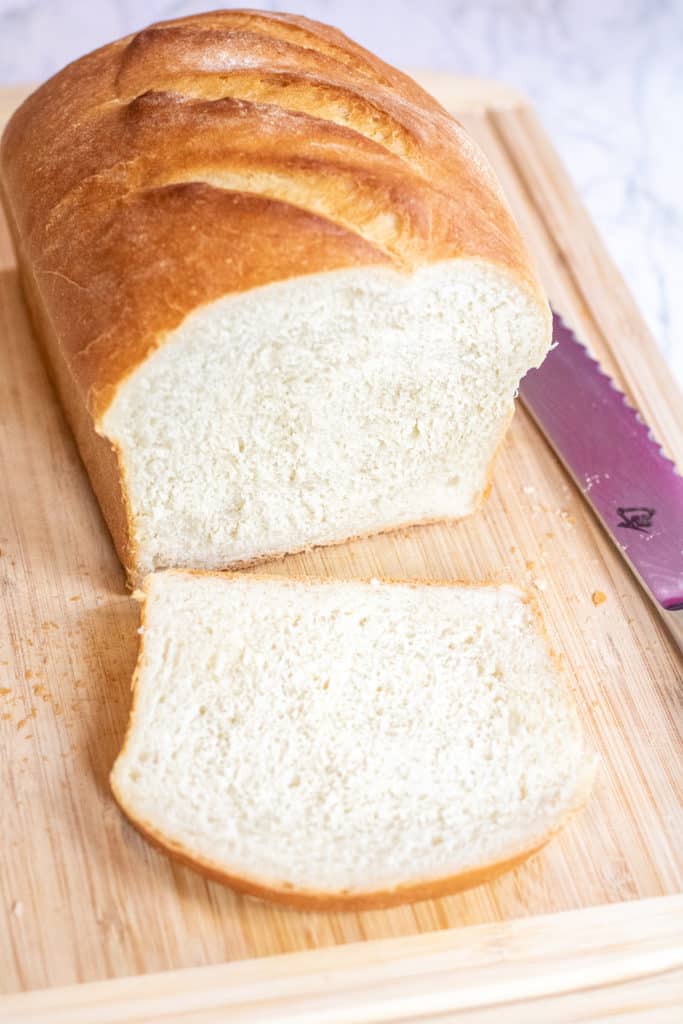 sliced white bread on a cutting board.