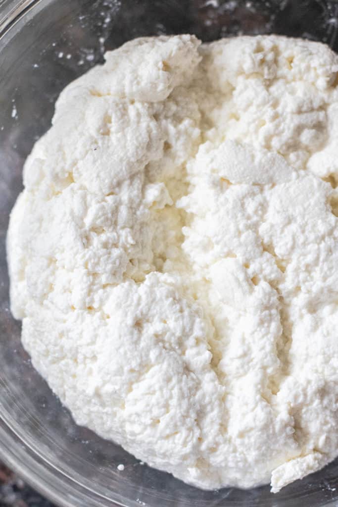 close up of fresh ricotta cheese in a bowl