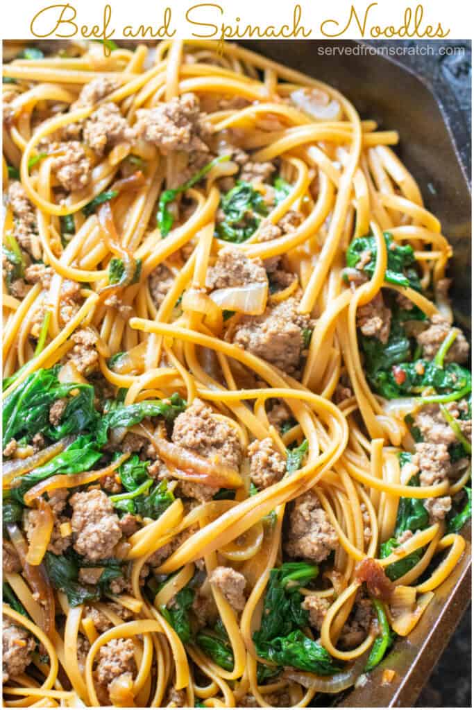 beef and spinach noodles in cast iron with Pinterest pin text.
