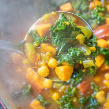 dutch oven of cooked chickpeas, sweet potato, kale soup.