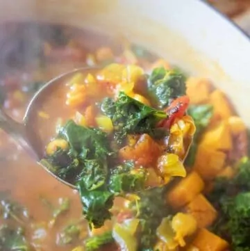 dutch oven of cooked chickpeas, sweet potato, kale soup.