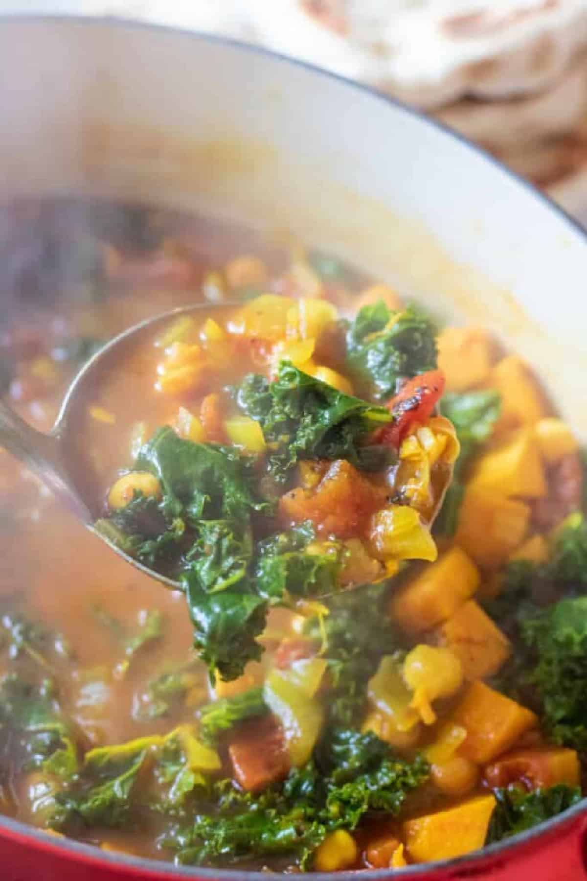 dutch oven of cooked chickpeas, sweet potato, kale soup.