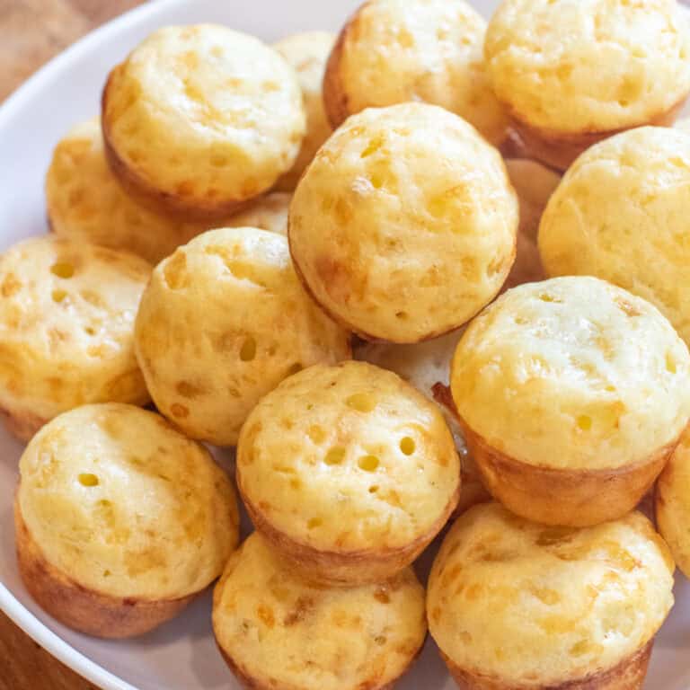 a bowl of small baked Brazilian cheese breads.