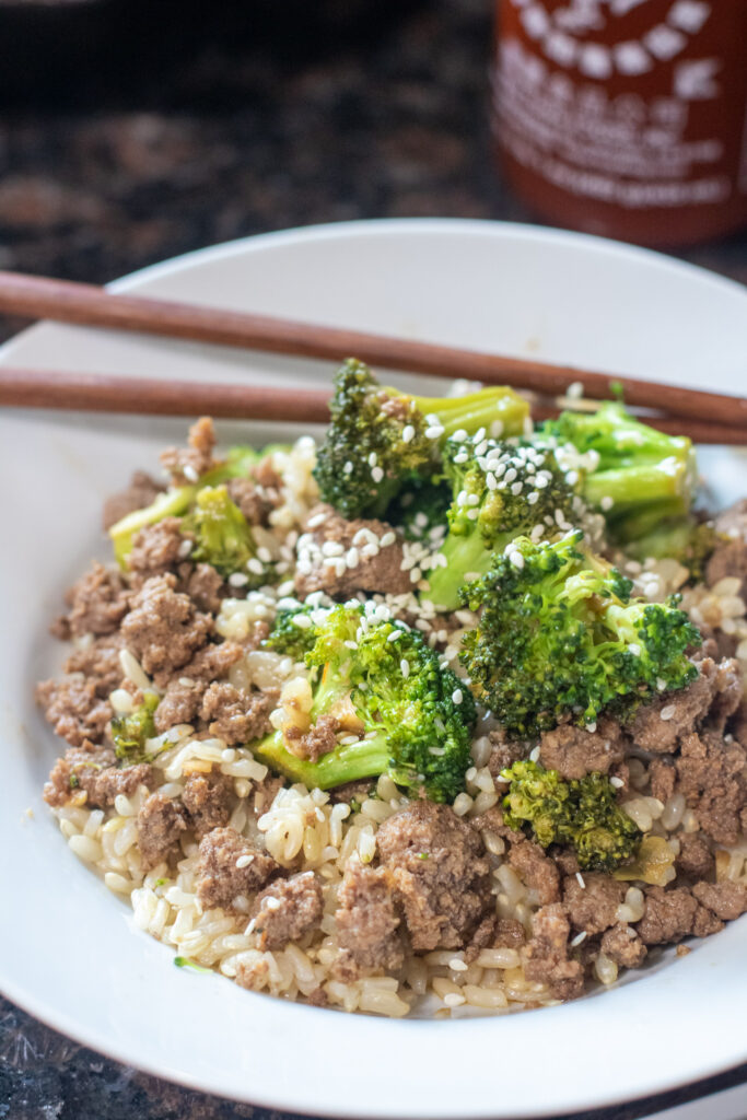 cooked ground beef and broccoli over a bed of rice.