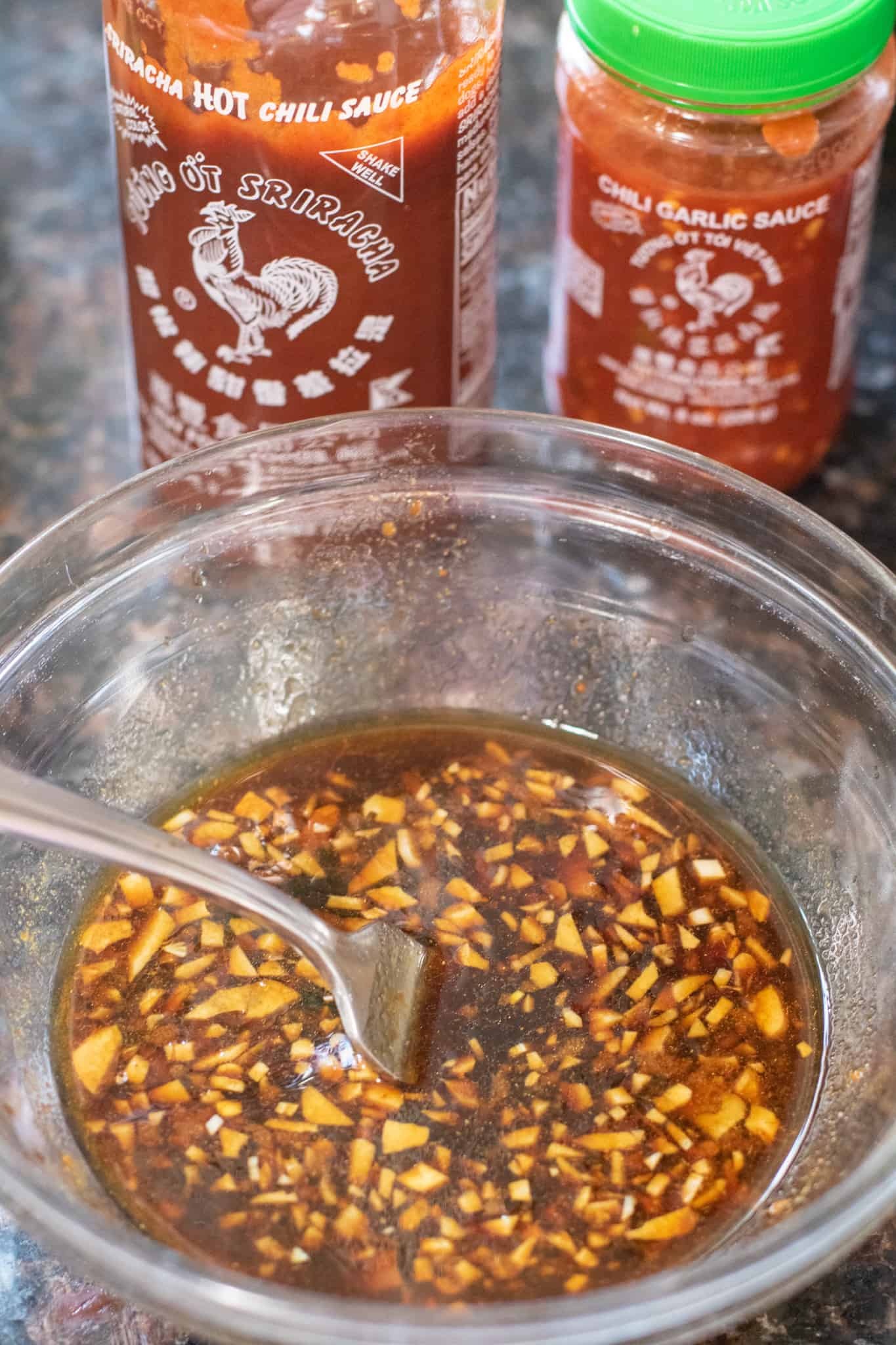 Sriracha and garlic sauce in a bowl with a fork.