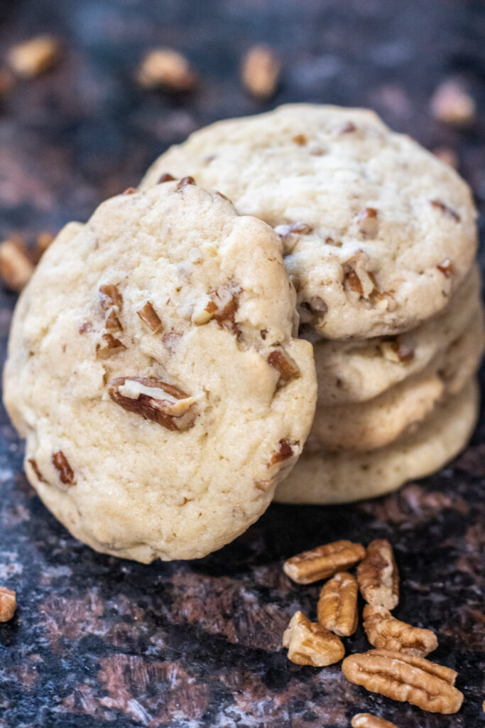 Sandies cookies stacked with pecans around