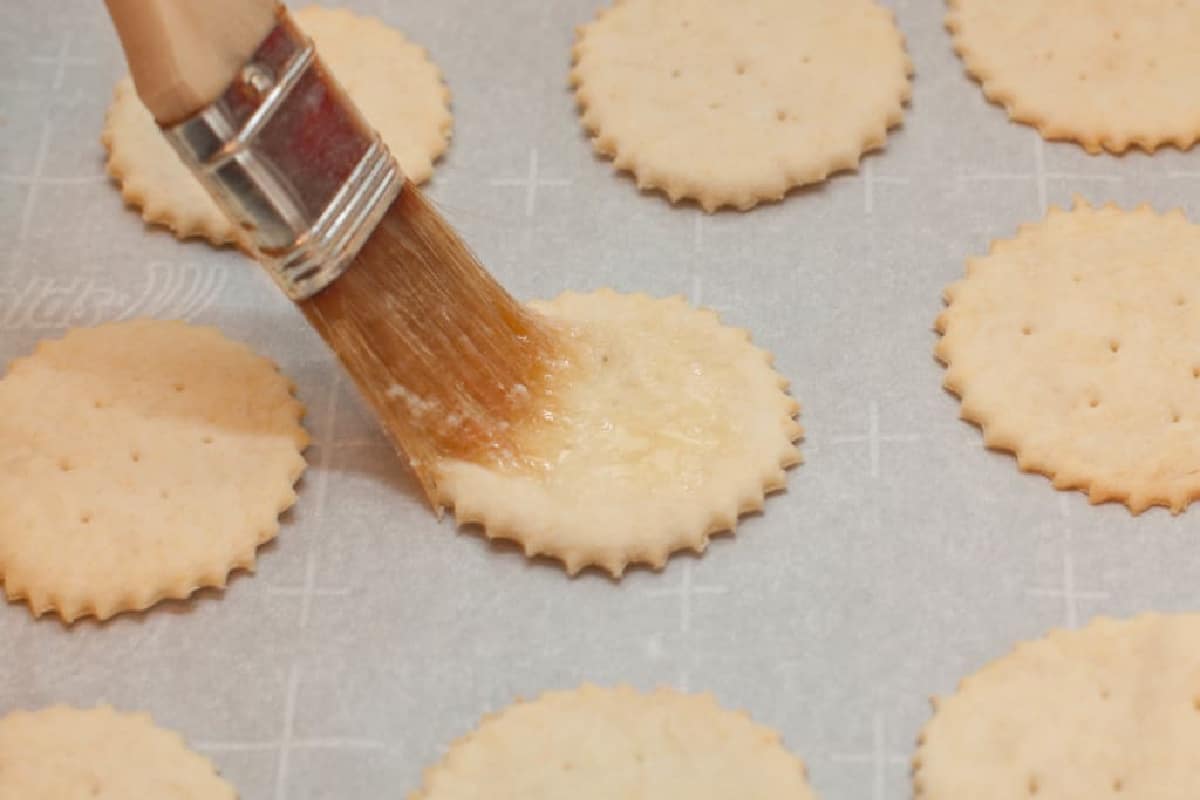 brushing dough circles with butter.