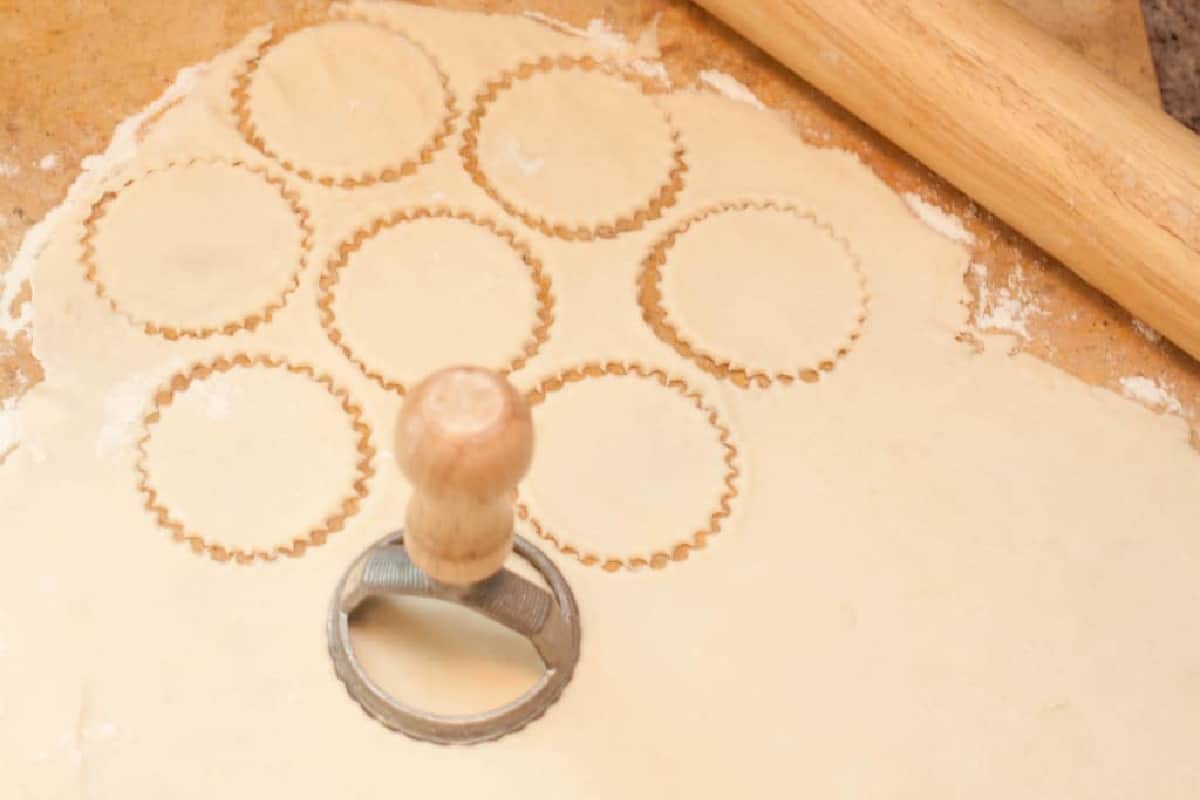 a dough cutter cutting out circles.