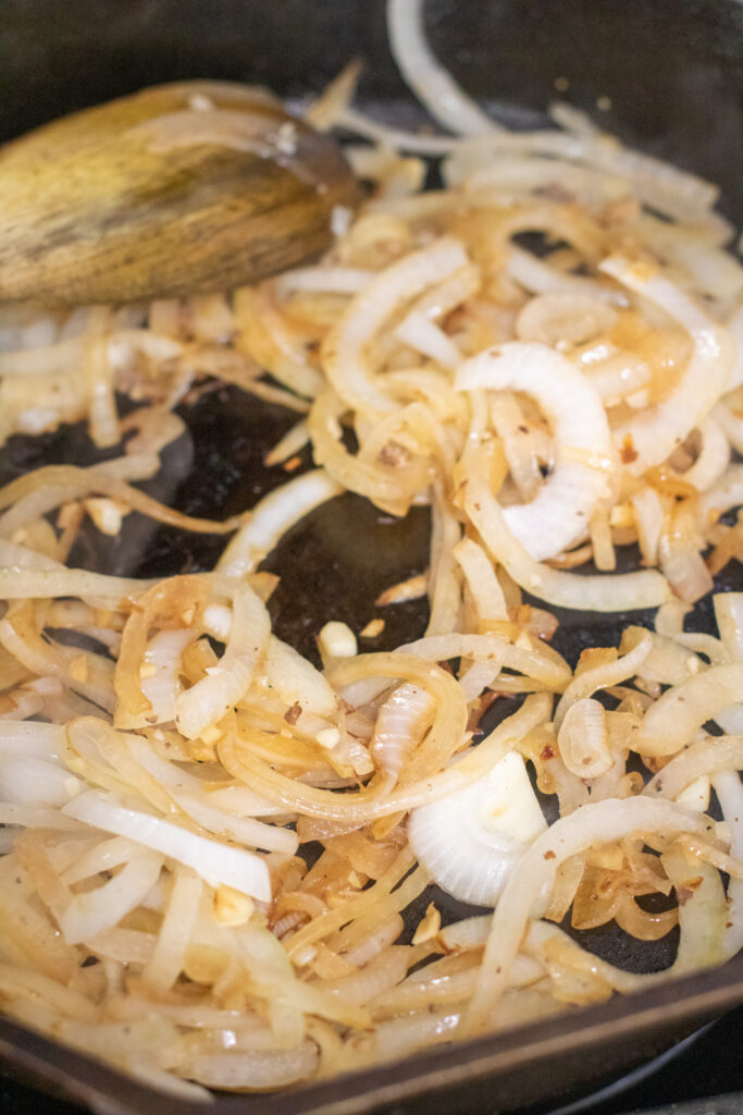 grilled onions and garlic in a cast iron