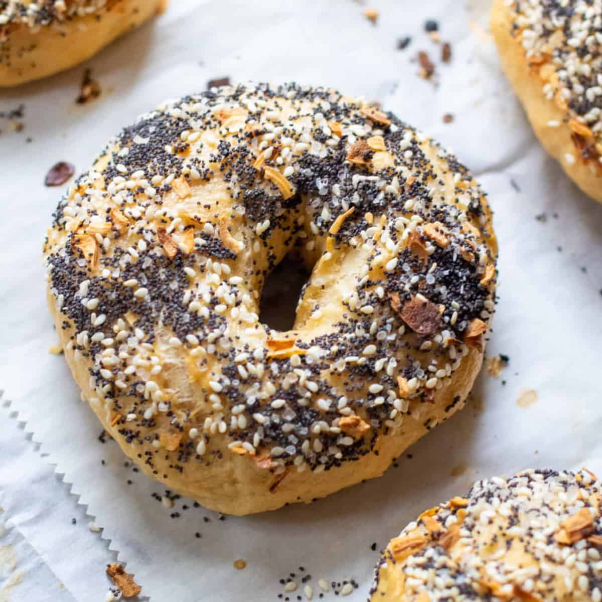 an everything bagel on parchment paper with others.