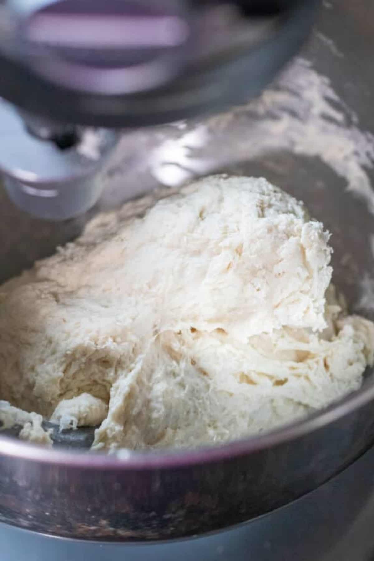 a stand mixer with dough in it. 