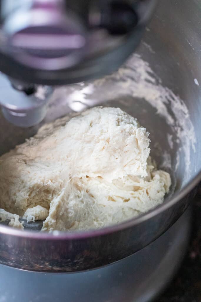 sticky bagel dough in a stand mixer mixed