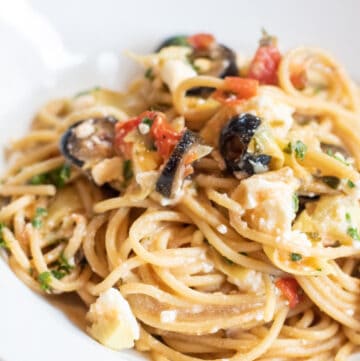 greek pasta with olive and tomatoes and feta cheesein a bowl.