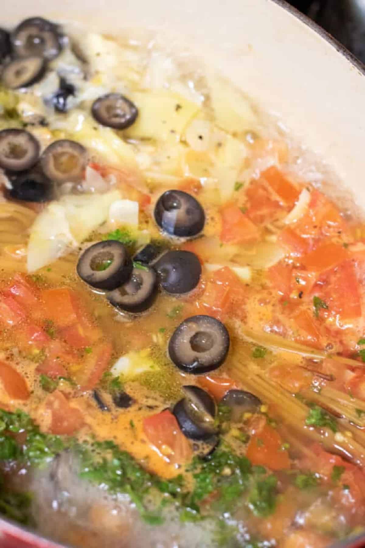 ingredients for greek pasta all in pot and boiling.