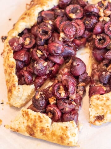 a slice cut out of a cherry galette.