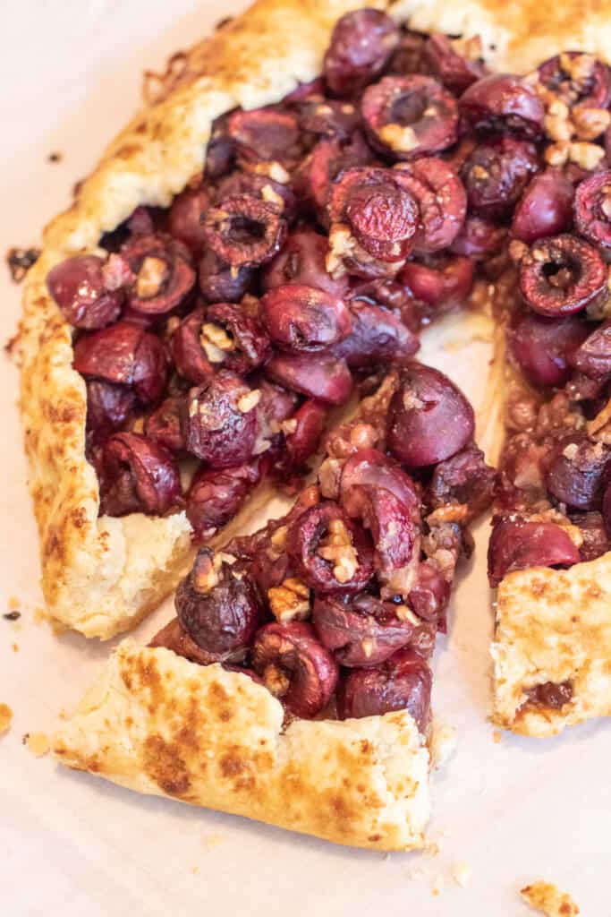 a slice cut out of a cherry galette 