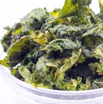 a bowl filled with crispy kale chips.