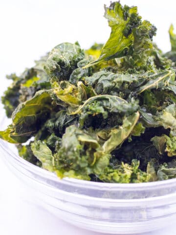 a bowl filled with crispy kale chips.