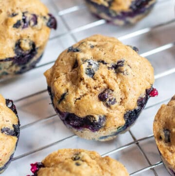 blueberry muffins on a cooling rack.