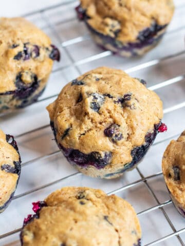 blueberry muffins on a cooling rack.