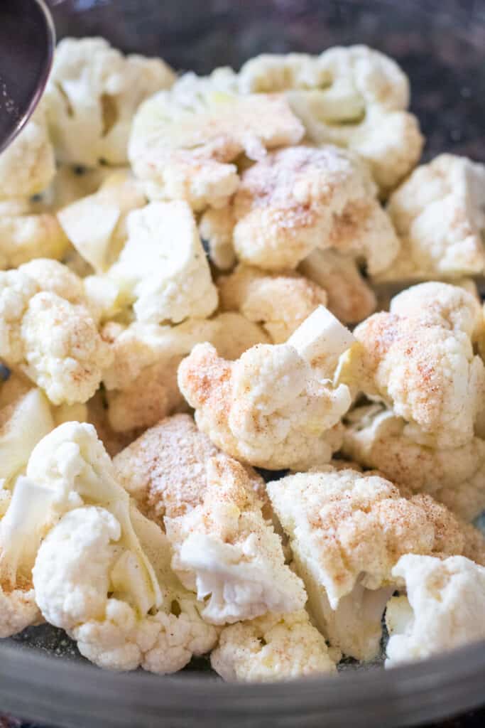 raw cauliflower with spices in a bowl