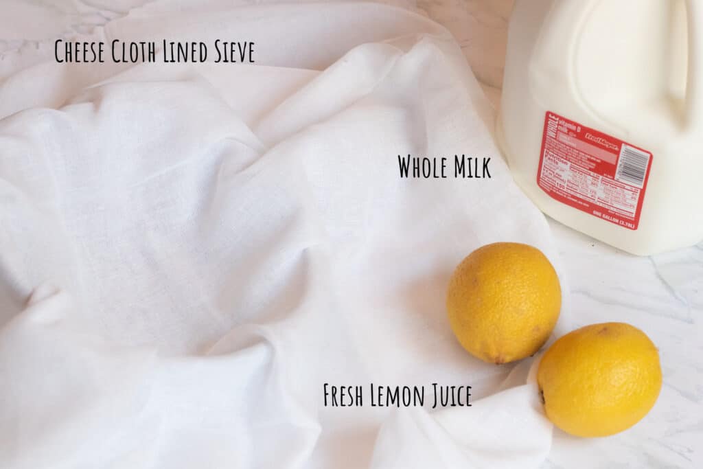 cheese cloth lined sieve, lemons, and milk