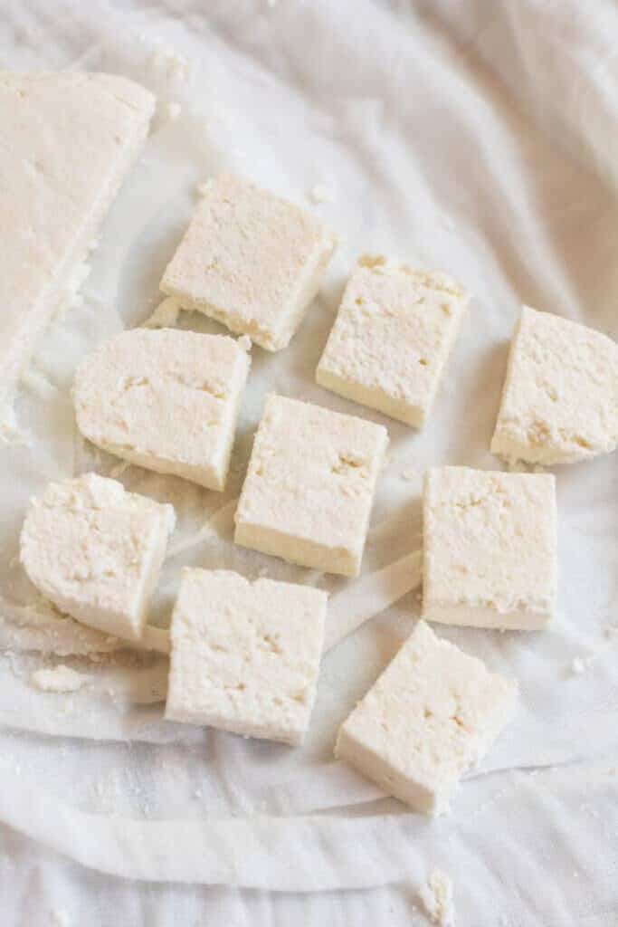 sliced and cut paneer in a cheesecloth.