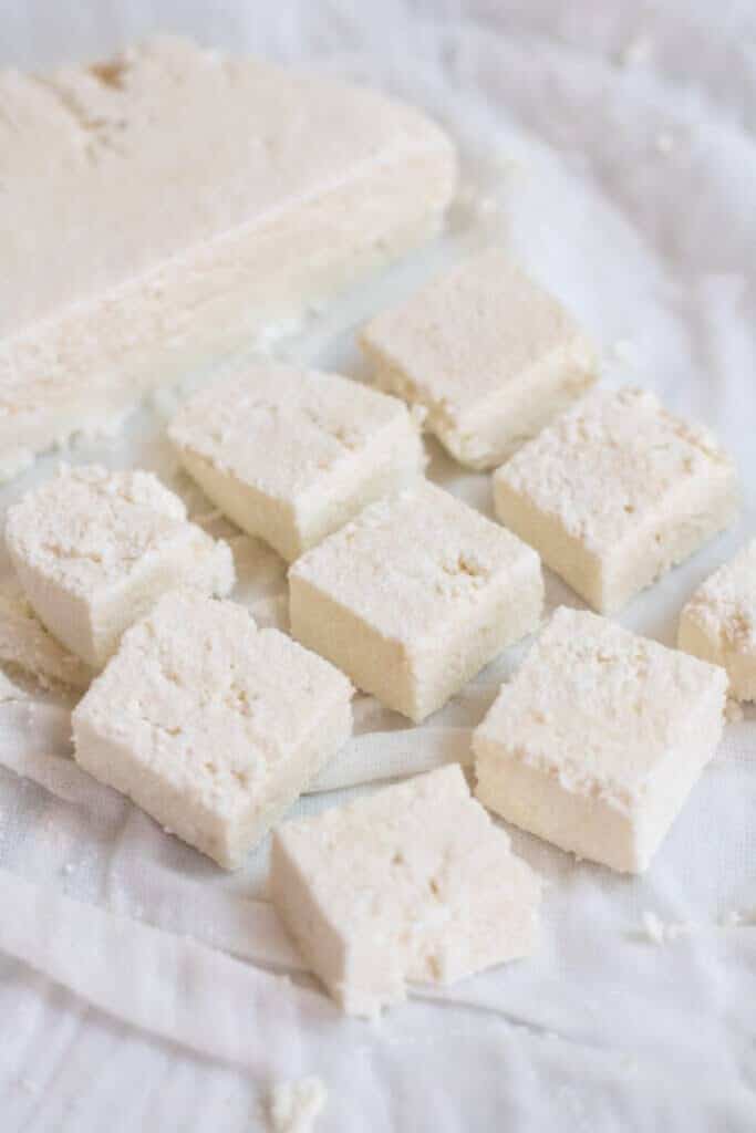 sliced and cut paneer in a cheesecloth.
