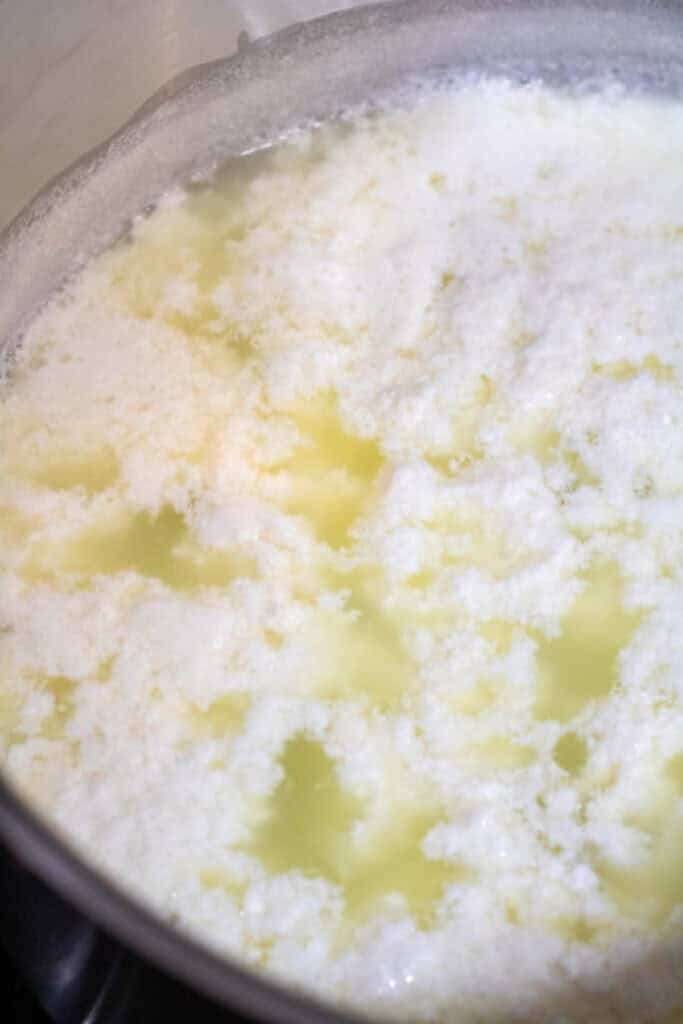 whey and curds in a pot.