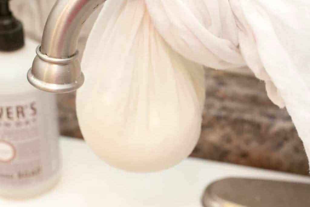 a cheesecloth hanging on a sink faucet.